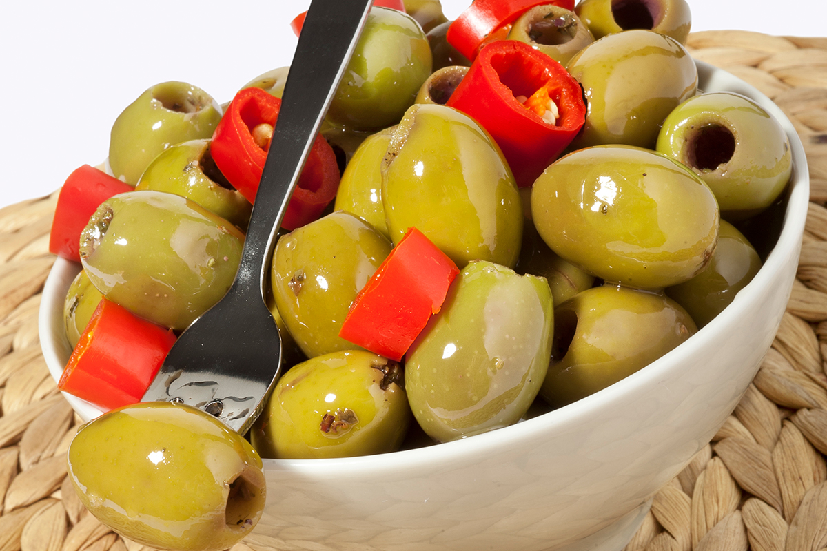 Green spicy pitted olives with lemon